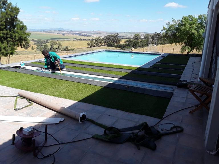Artificial grass around pool area project DURING SimpleGrassTurf co za